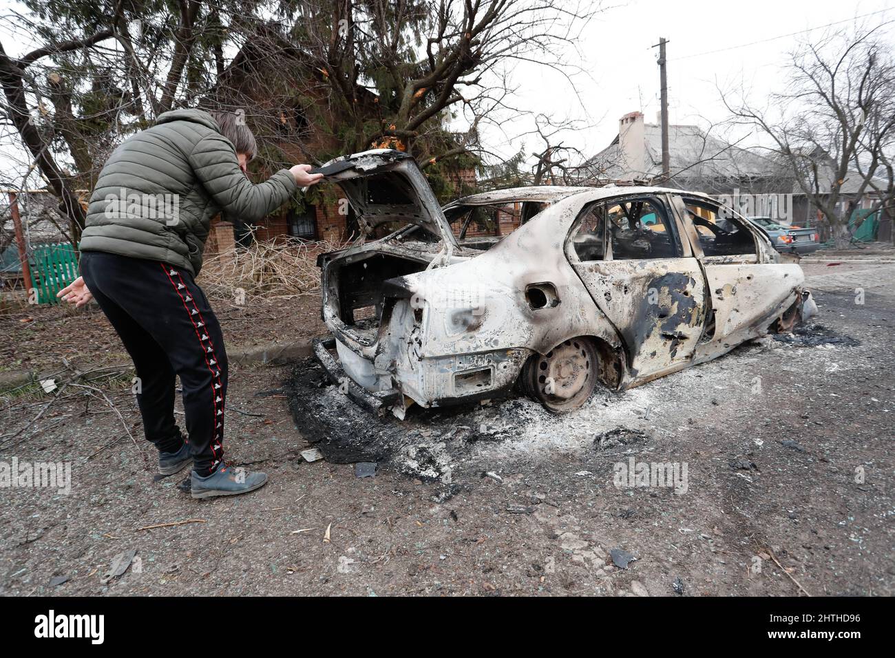 Donetsk. 28th Feb, 2022. A man checks a burnt car in Donetsk, Feb. 28, 2022. Credit: Victor/Xinhua/Alamy Live News Stock Photo