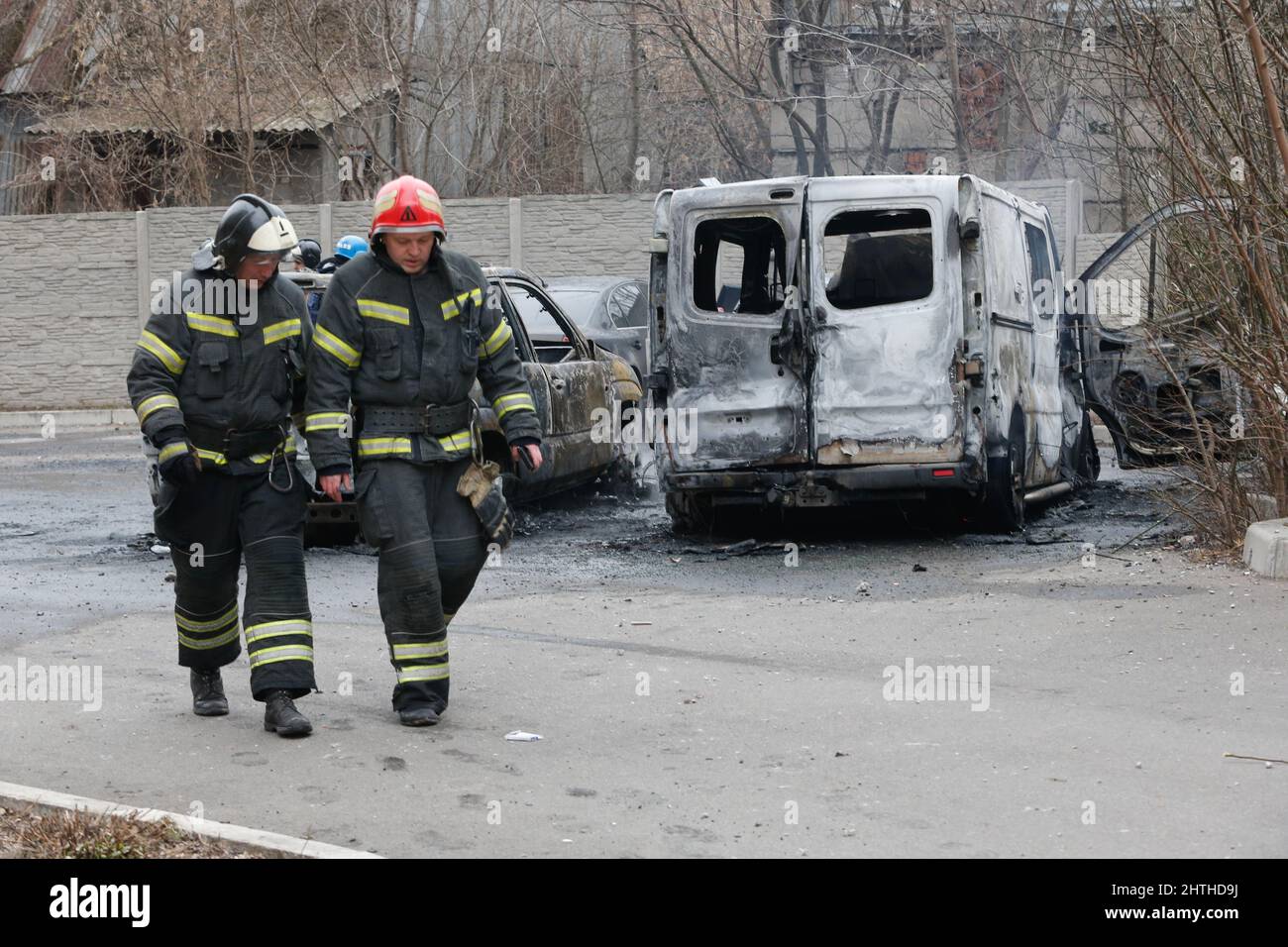 Donetsk. 28th Feb, 2022. Firefighters walk past burnt cars in Donetsk, Feb. 28, 2022. Credit: Victor/Xinhua/Alamy Live News Stock Photo
