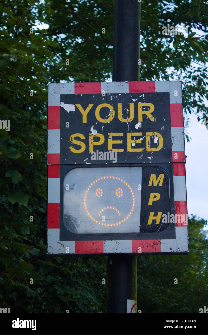 Digital speed limit sign, displaying an unhappy face. Speed kills concept Stock Photo