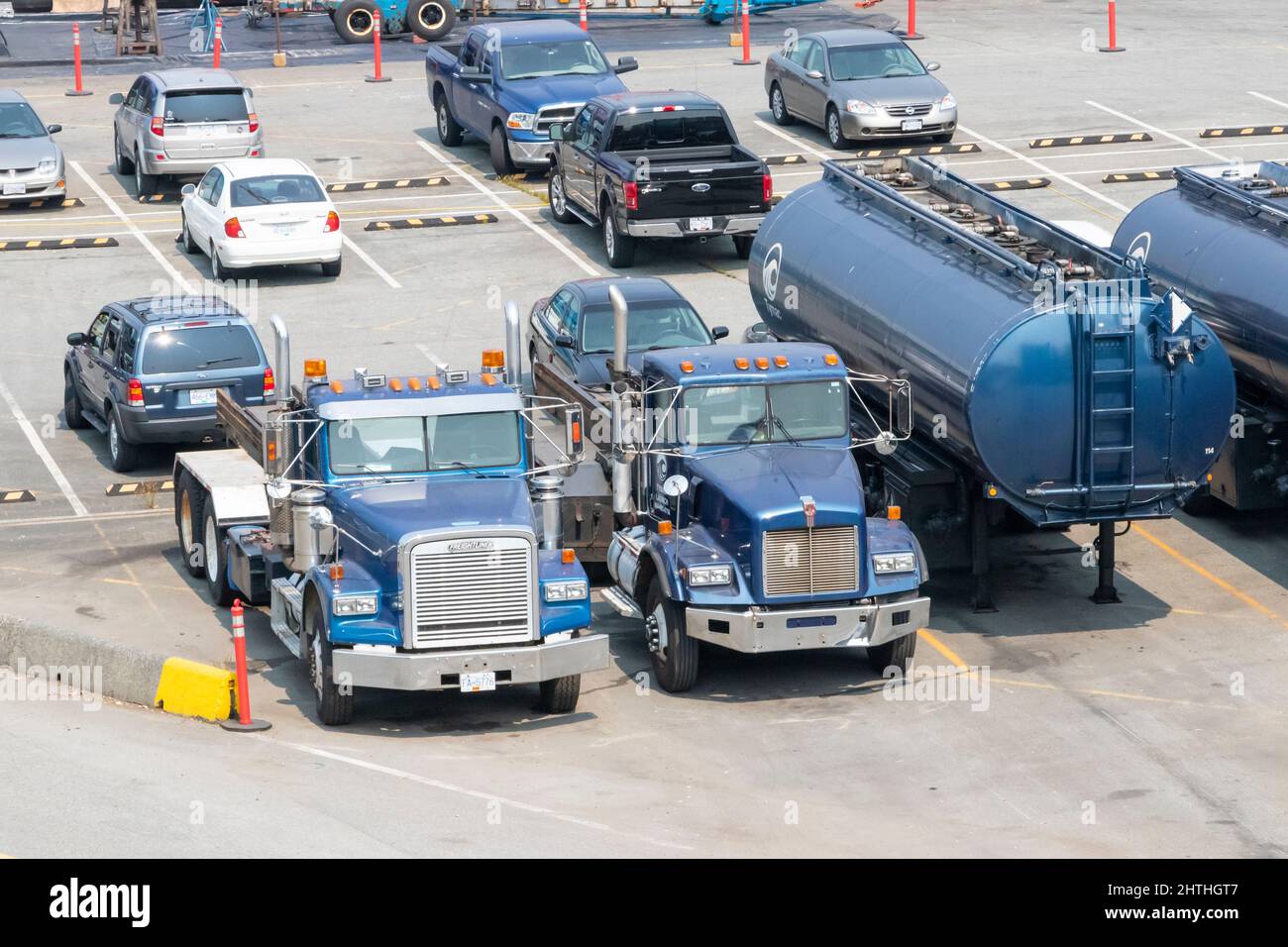 blue trucks cabs and trailer or semi and articulated tanker in yard Stock Photo