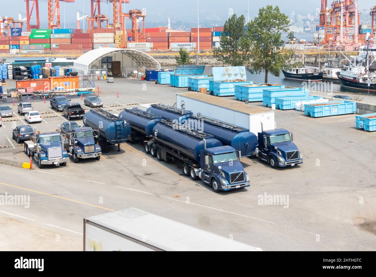 blue Volvo truck and trailer or semi and articulated tankers in yard Stock Photo
