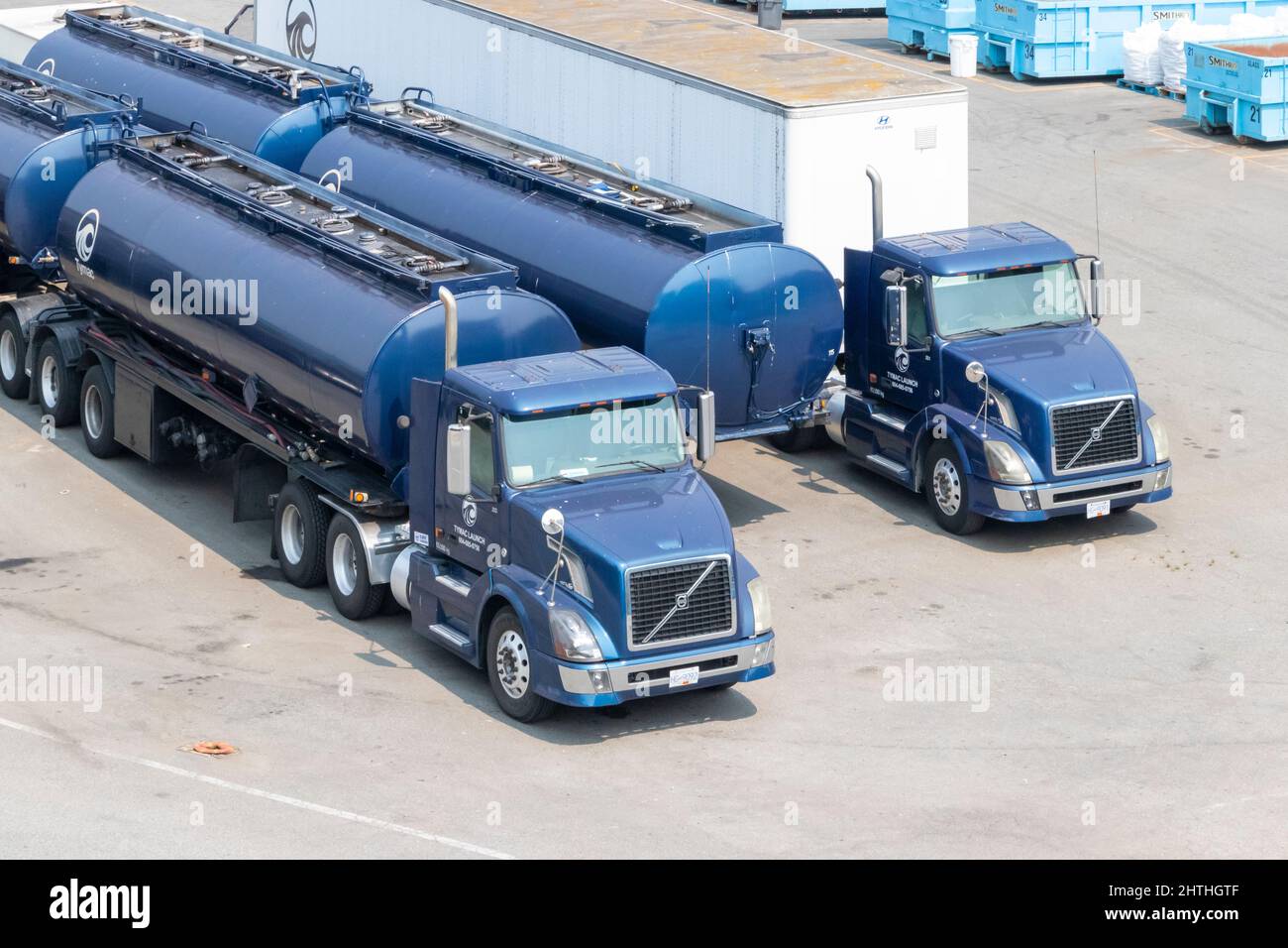 blue Volvo truck and trailer or semi and articulated tankers in yard Stock Photo