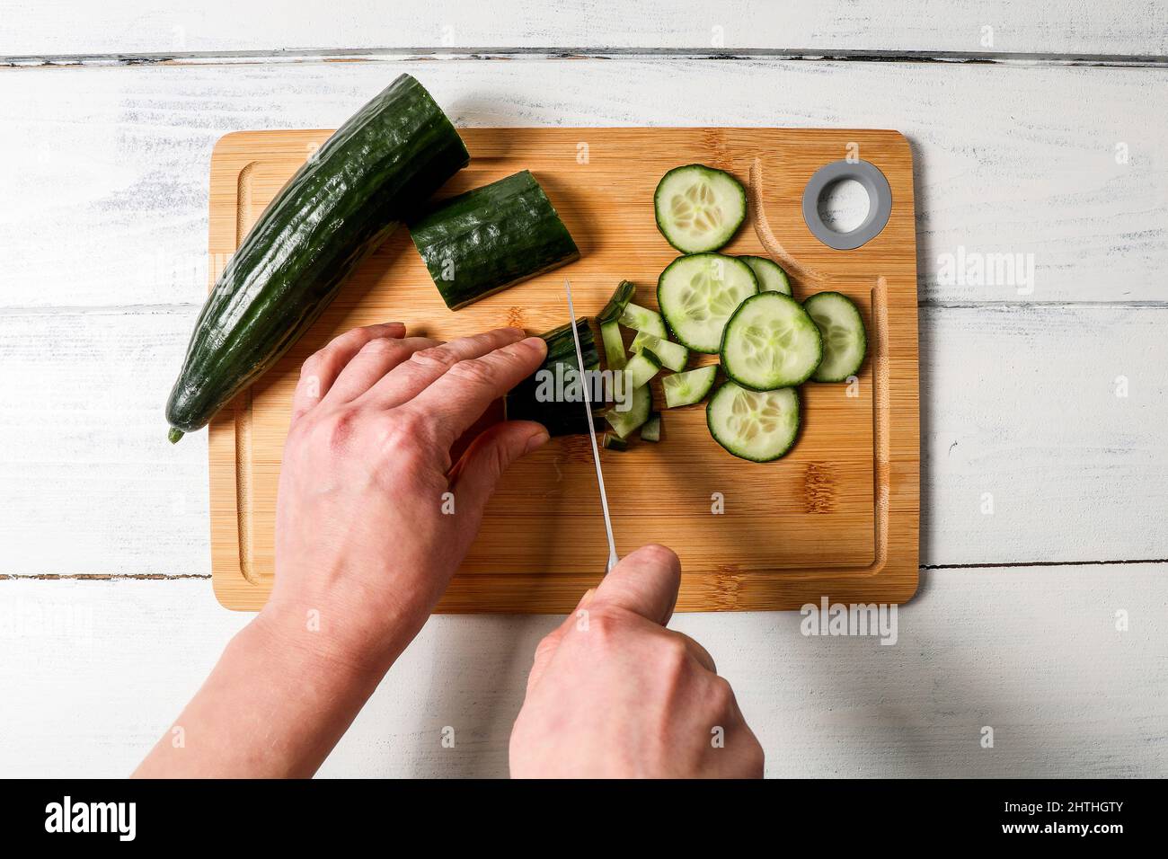 Cut cucumber into pieces. Fresh food and vitamins Stock Photo Alamy