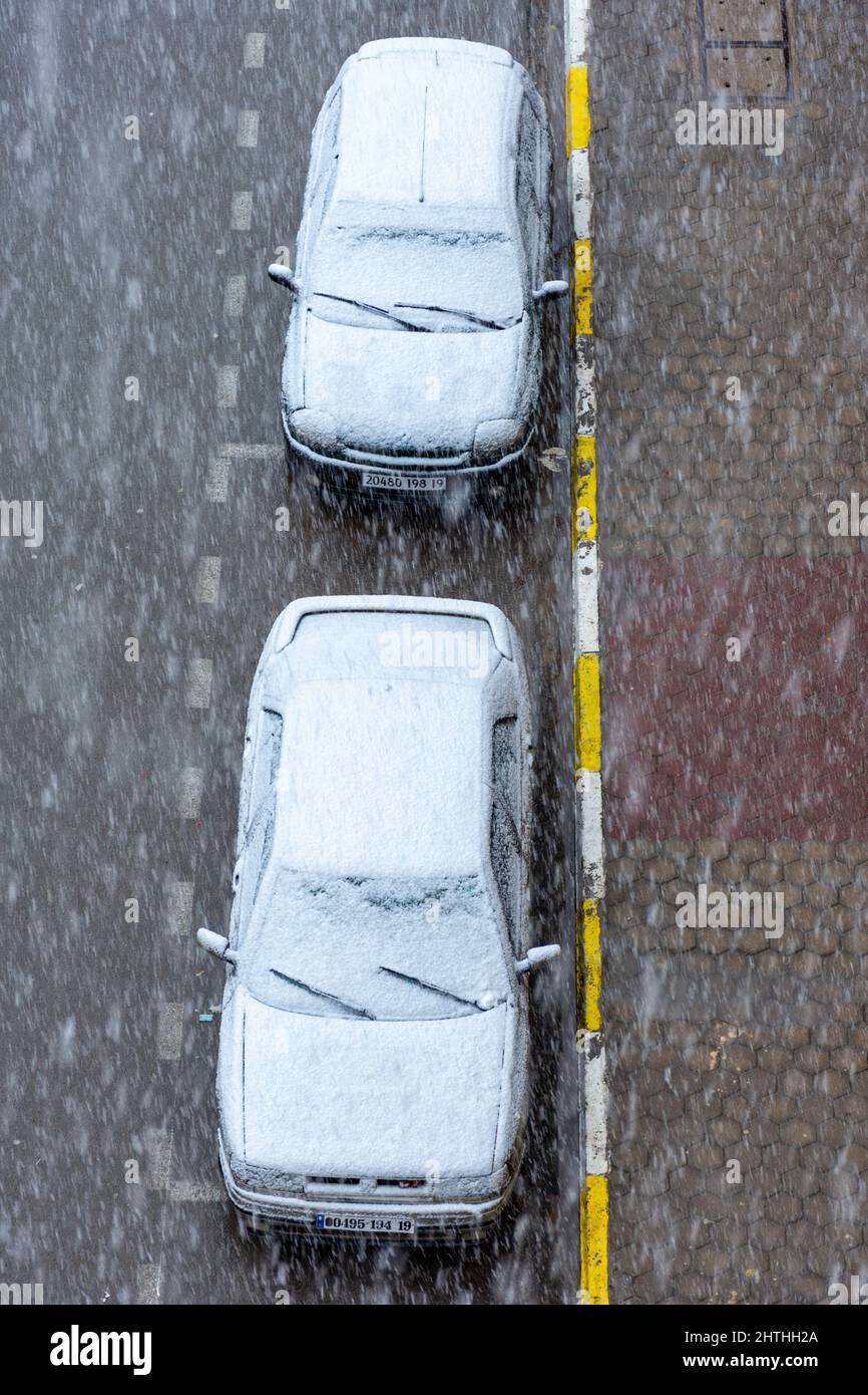 Top view of two cars parked on the street covered with snow Stock Photo ...