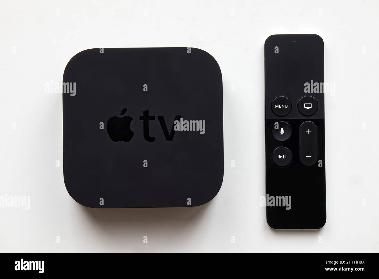 Apple TV and wireless remote on white background. Stock Photo