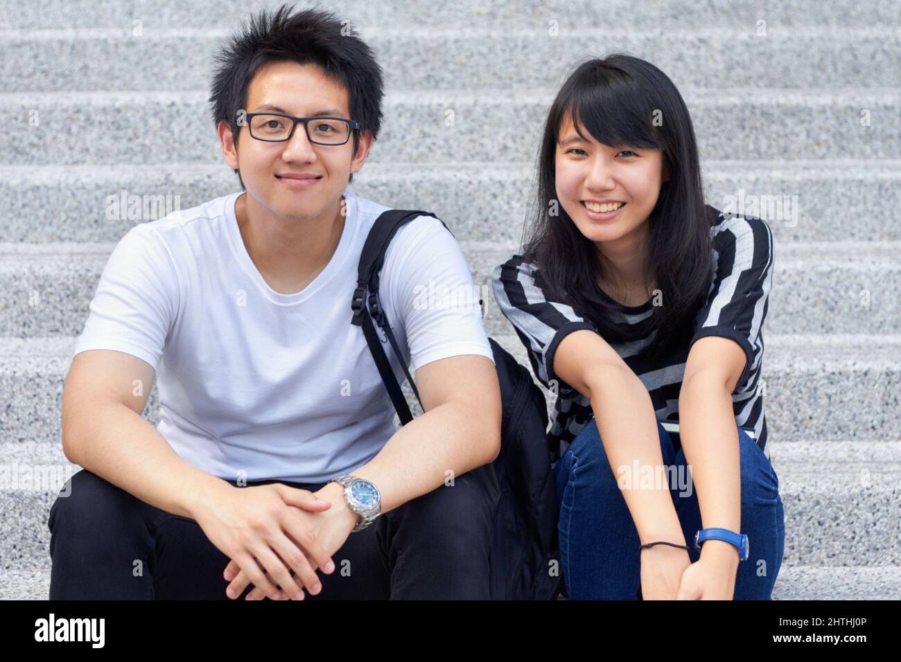 We love university. Two young students sitting outside together. Stock Photo