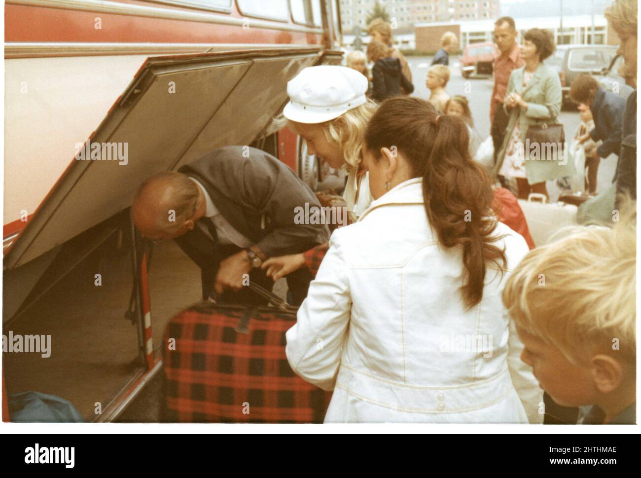 1970's photograph of luggage being packed on coach for school trip, Sweden. Stock Photo