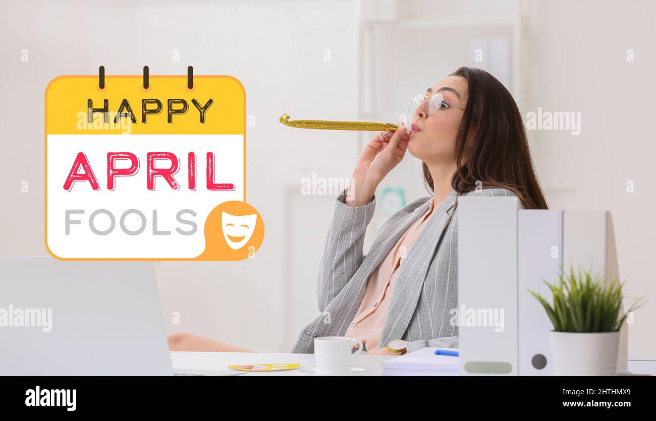 Young woman with party whistle in office. April fools day celebration ...