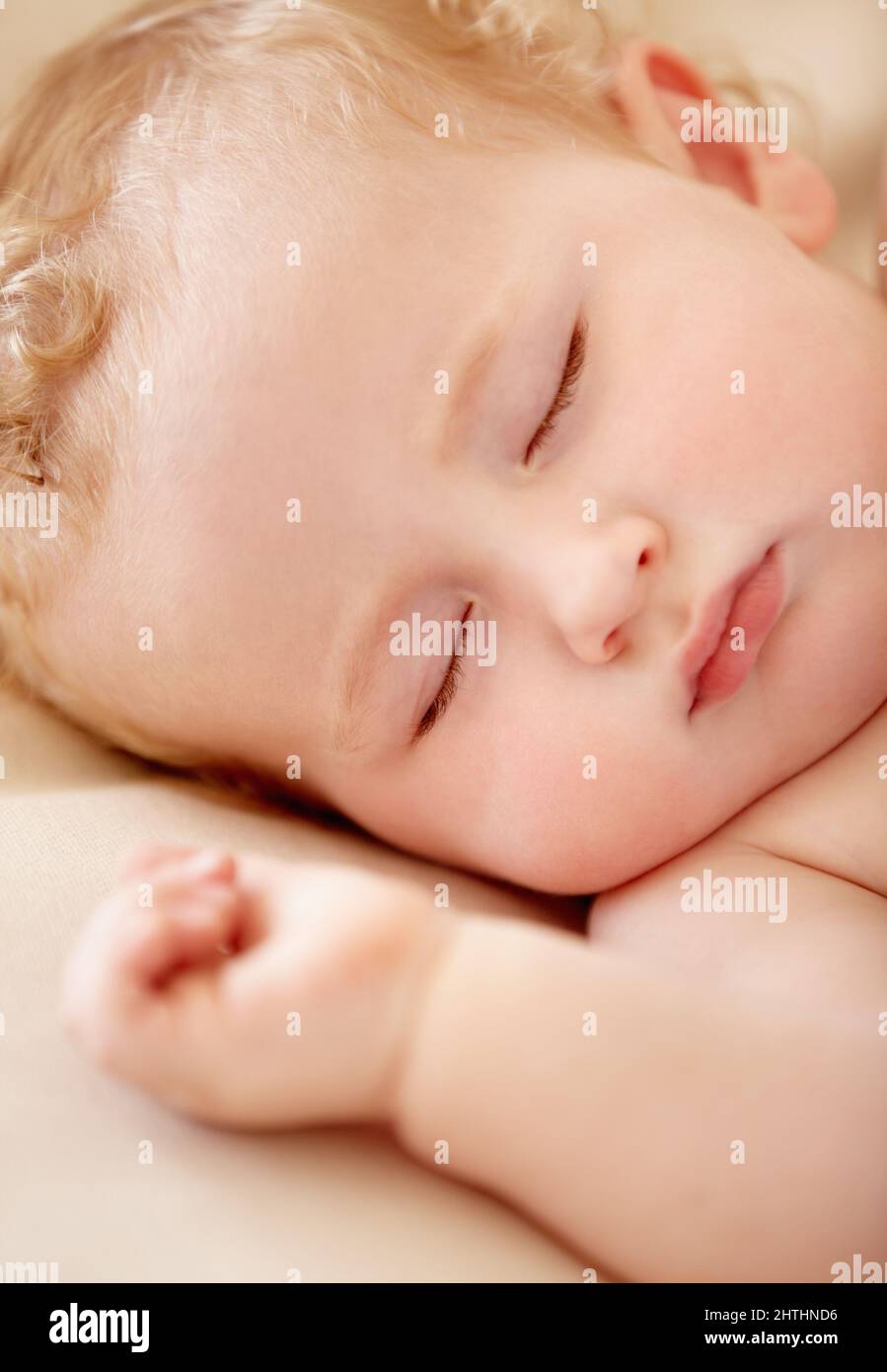 Napping soundly. Tiny baby boy lying fast asleep. Stock Photo