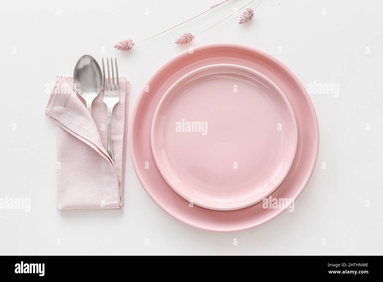 Elegant table setting with flowers on white background Stock Photo - Alamy