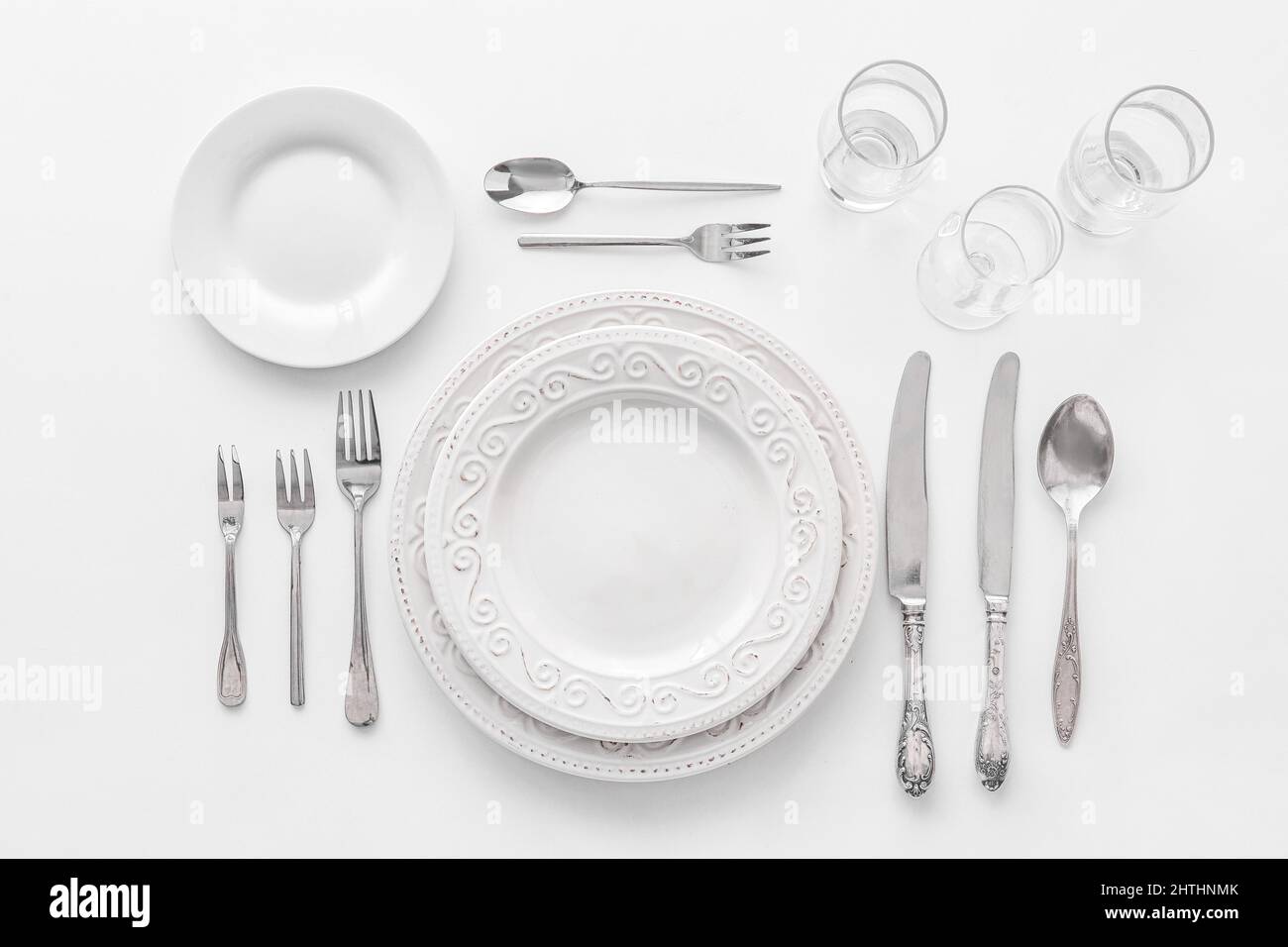Elegant table setting on white background Stock Photo - Alamy
