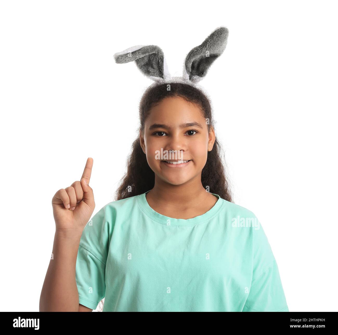 Cute AfricanAmerican girl with bunny ears and raised index finger on
