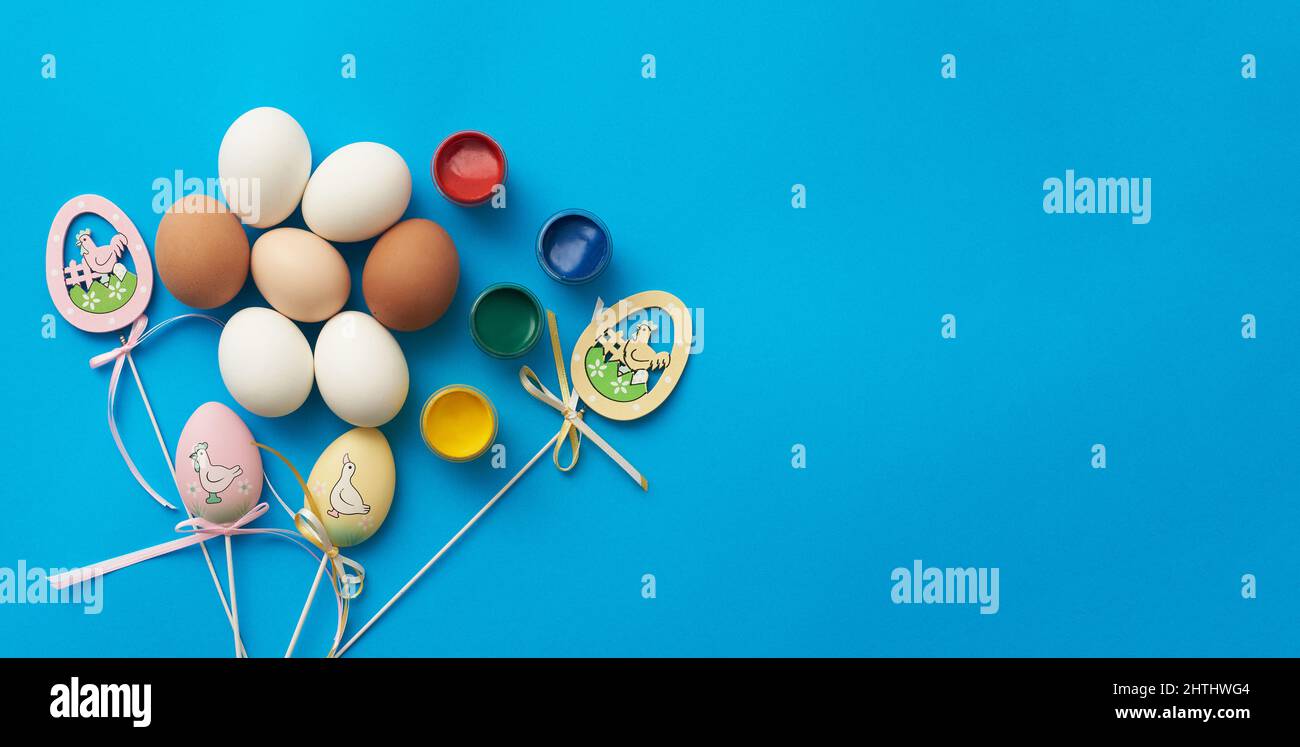 Template for easter holiday with eggs and paints and copy space Stock Photo