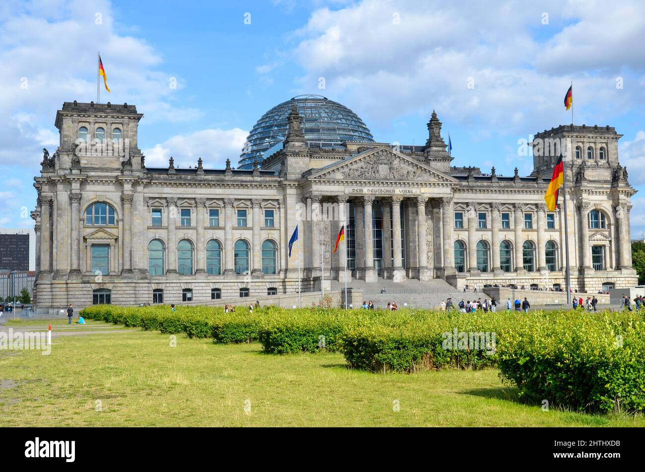 Berlin, Berlin, Germany - June 20 2014: View from the big meadow to the Reichstag building in Berlin with the big Reichstag dome and the German flags Stock Photo