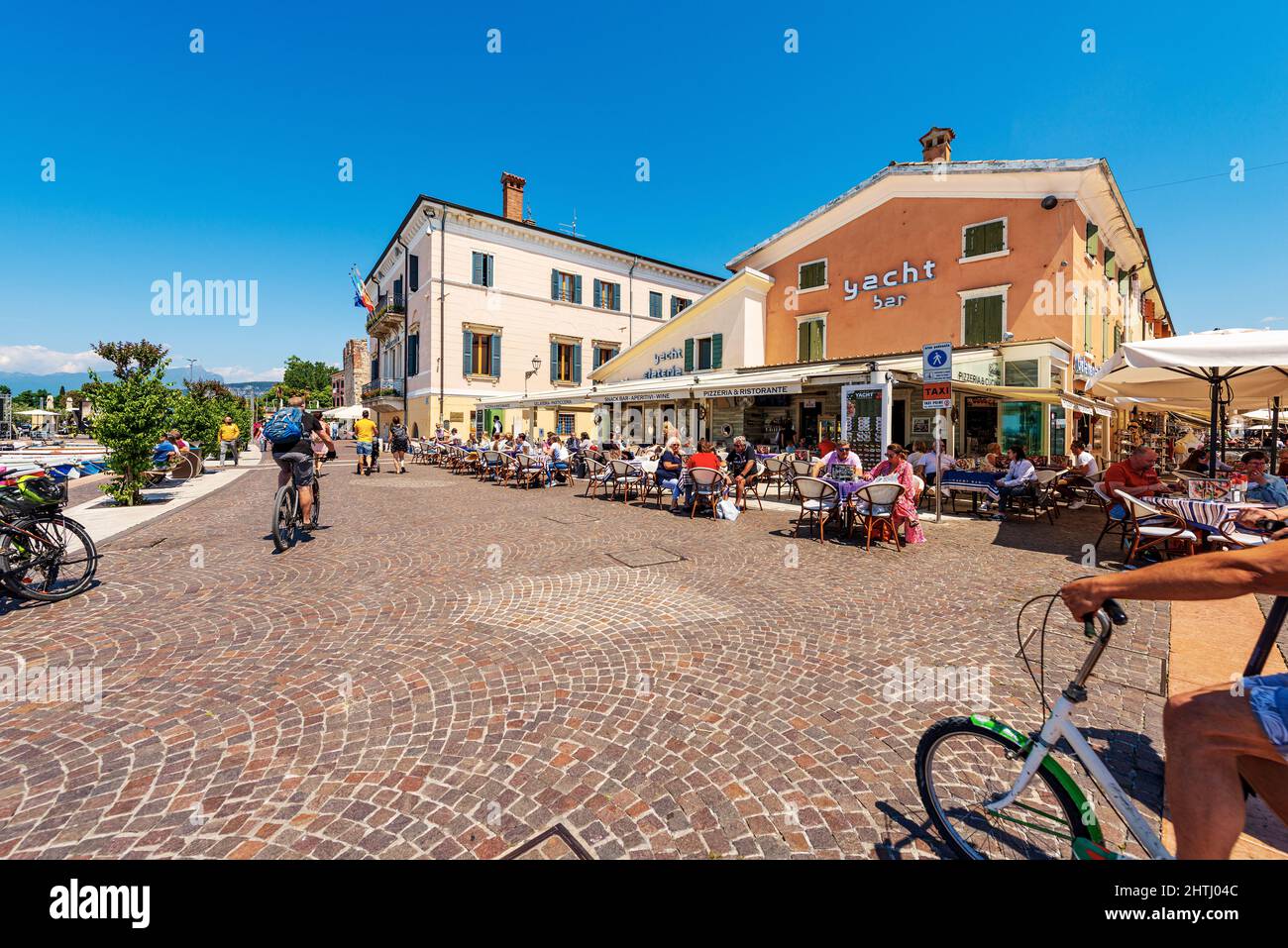 Downtown of Bardolino village, tourist resort on the coast of Lake Garda. Promenade with tourists, restaurants and pizzerias. Verona province, Italy. Stock Photo