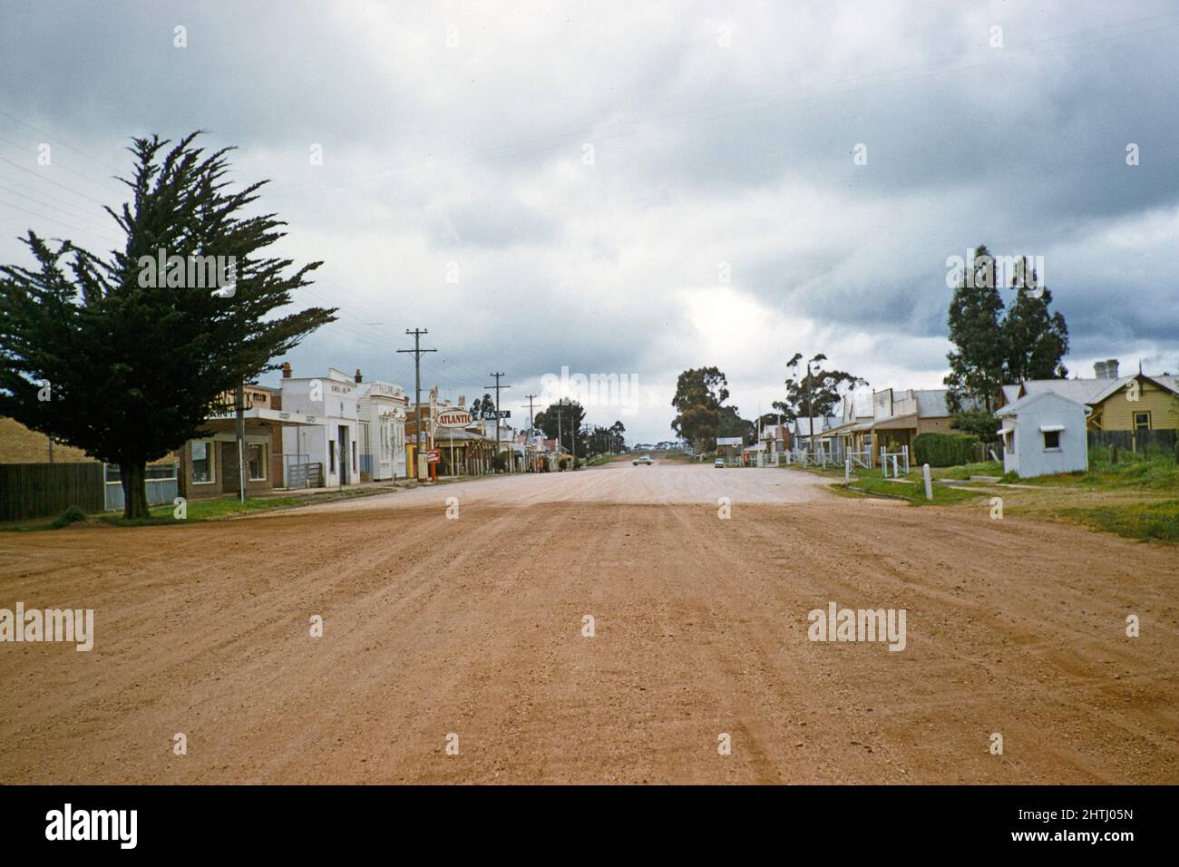 Shops and houses line street wide with unmade road, Willaura, Victoria