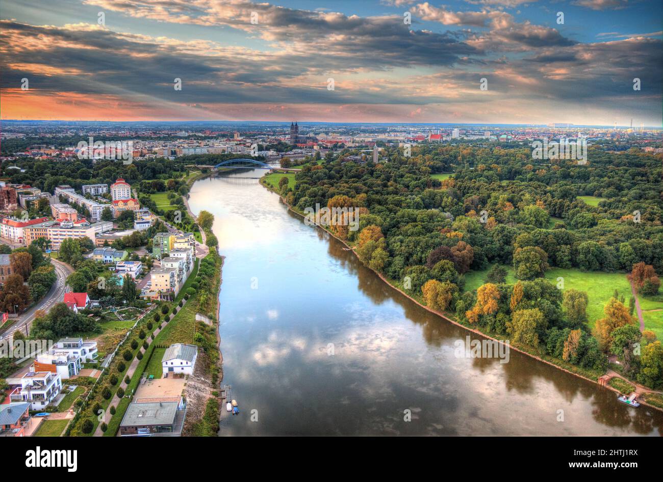 Aerial view of the riverside city surrounded by trees Stock Photo - Alamy