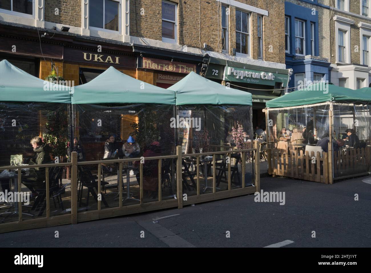 Visitors to street market, restaurants and cafes in Portobello Road