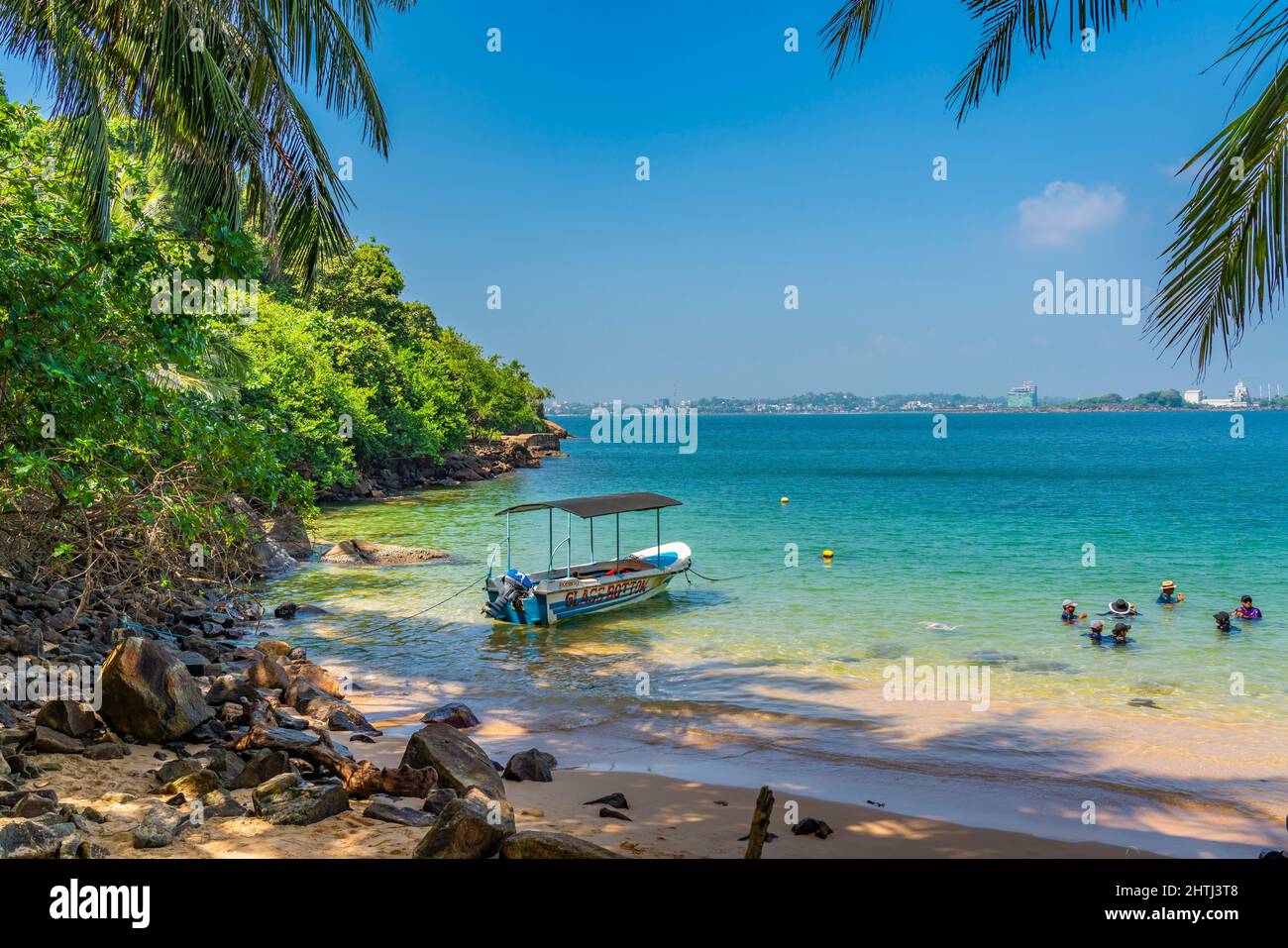 UNAWATUNA, SRI LANKA - DECEMBER 24, 2021: View of the Jungle Beach at Unawatuna, Galle with a boat Stock Photo