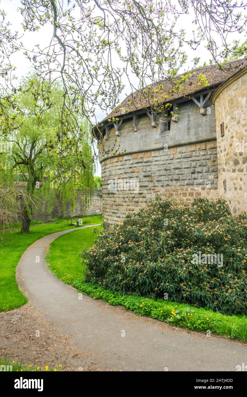 Old stone building in the park with bushes around and a narrow path ...