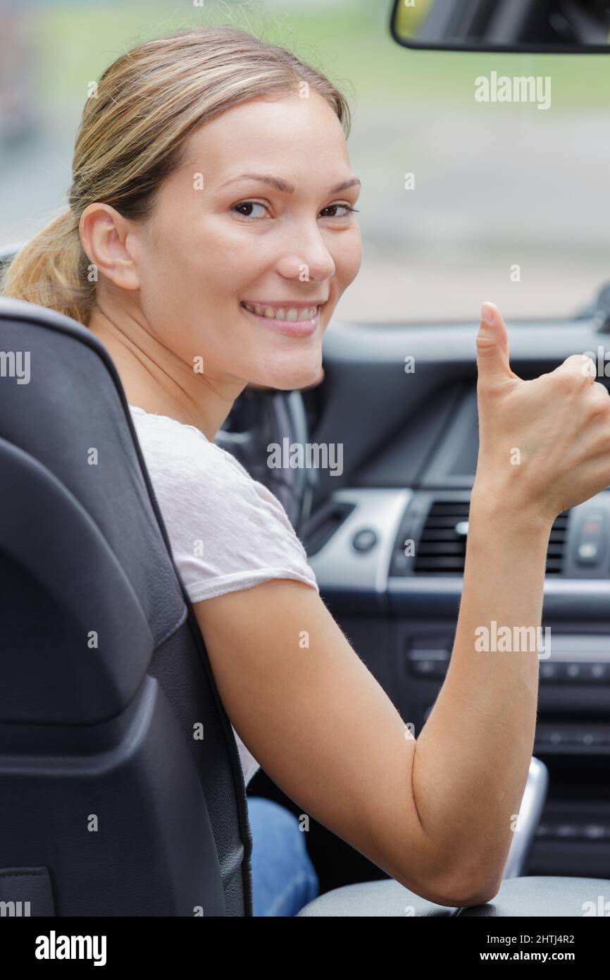 beautiful smiling girl with thumbs up signal Stock Photo - Alamy