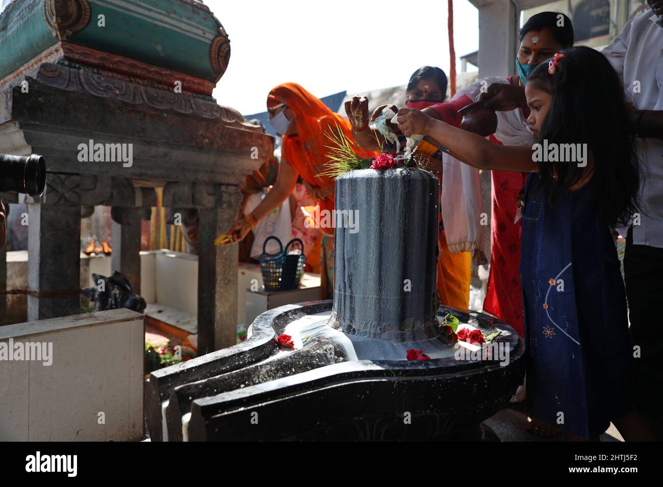 Chennai, Tamil Nadu, India. 1st Mar, 2022. Hindu devotees perform rituals of pouring milk and water onto a Shiva Lingam, a stone sculpture representing Hindu Lord Shiva, on the occasion of the Maha Shivratri festival at a temple in Chennai. (Credit Image: © Sri Loganathan/ZUMA Press Wire) Stock Photo