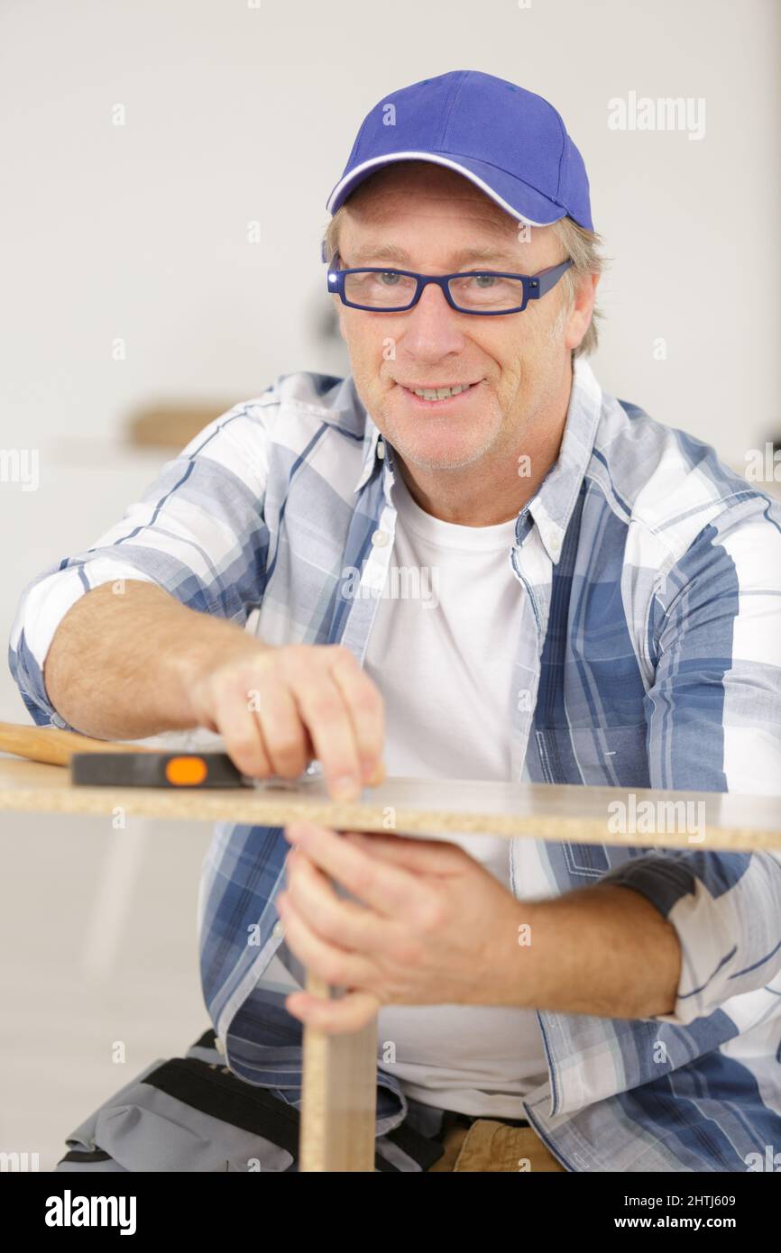 skilled carpenter cutting a piece of wood Stock Photo Alamy