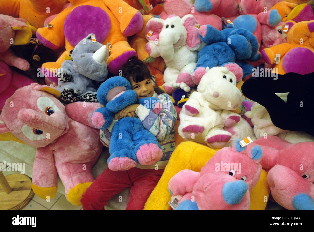 little girl playing with soft toy Stock Photo Alamy