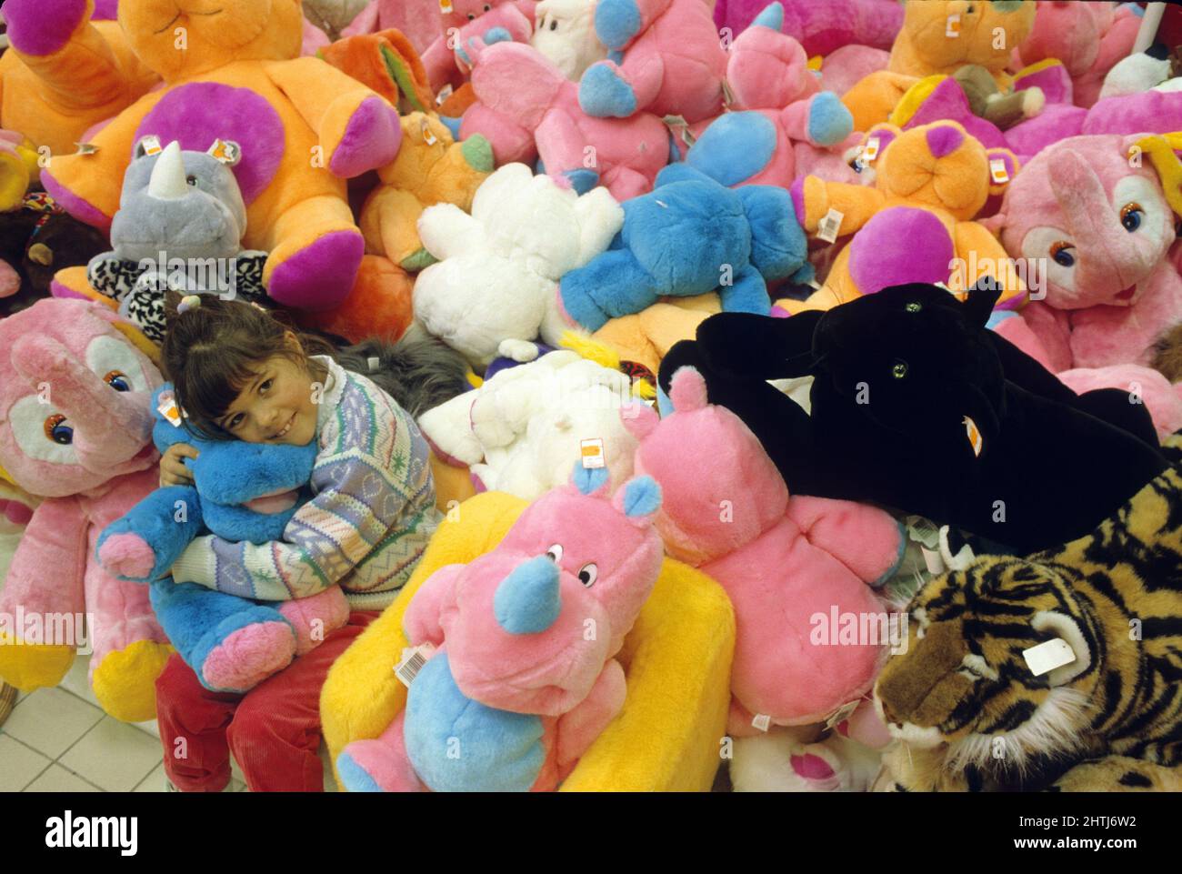 little girl playing with soft toy Stock Photo Alamy