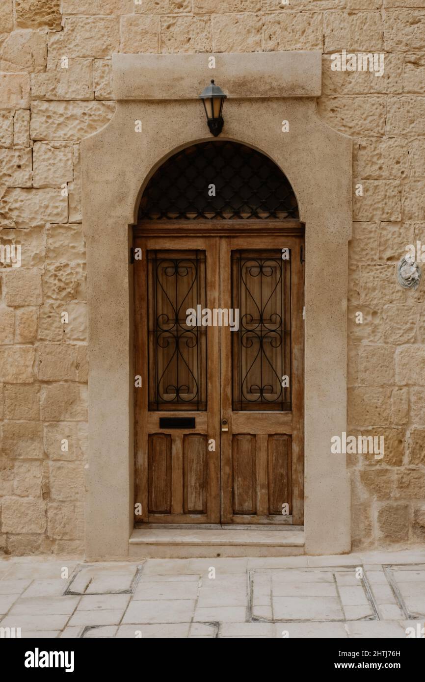 Old wooden door in brick wall Stock Photo