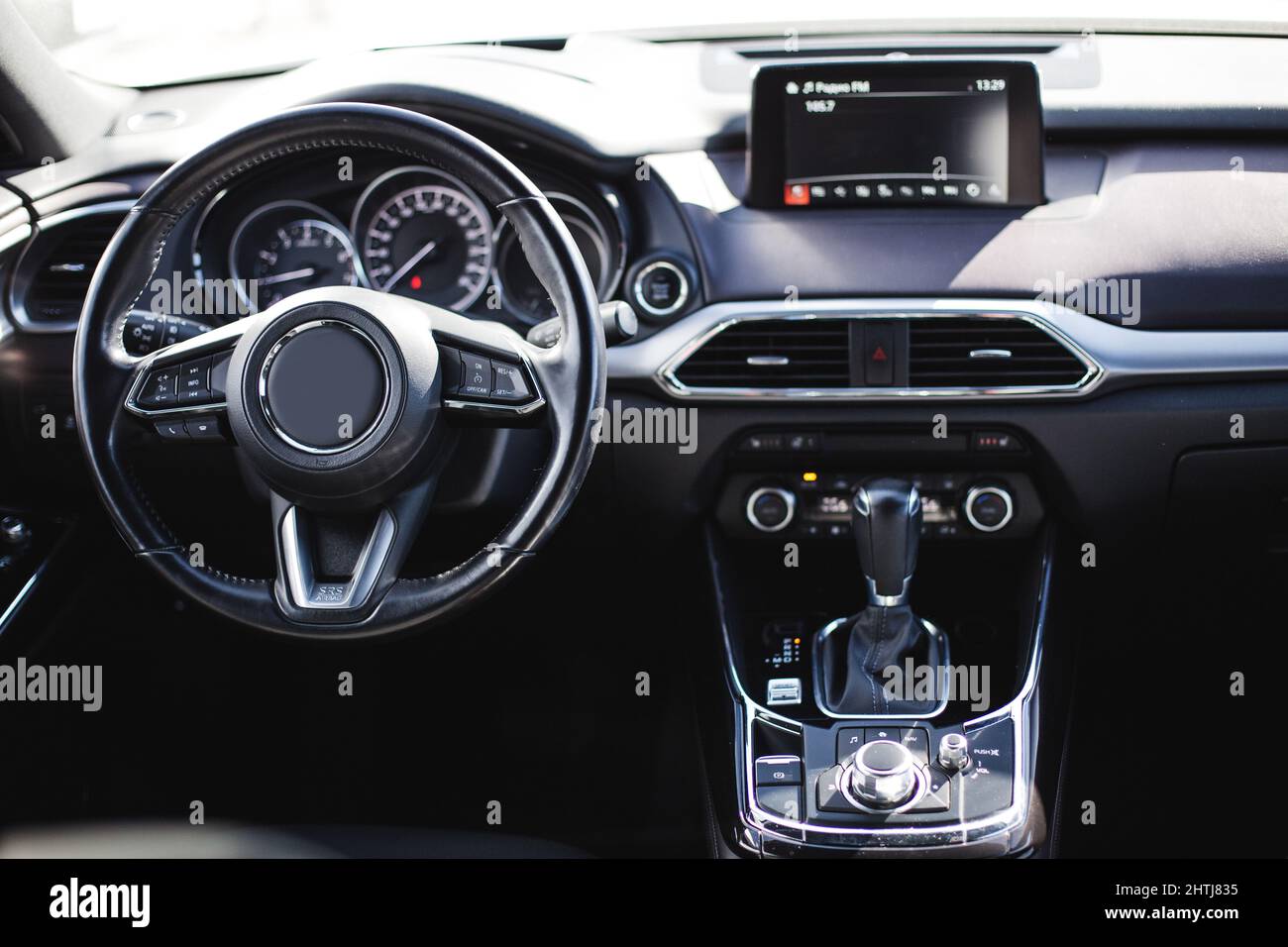 Car interior luxury steering wheel. Dashboard, climate control, display
