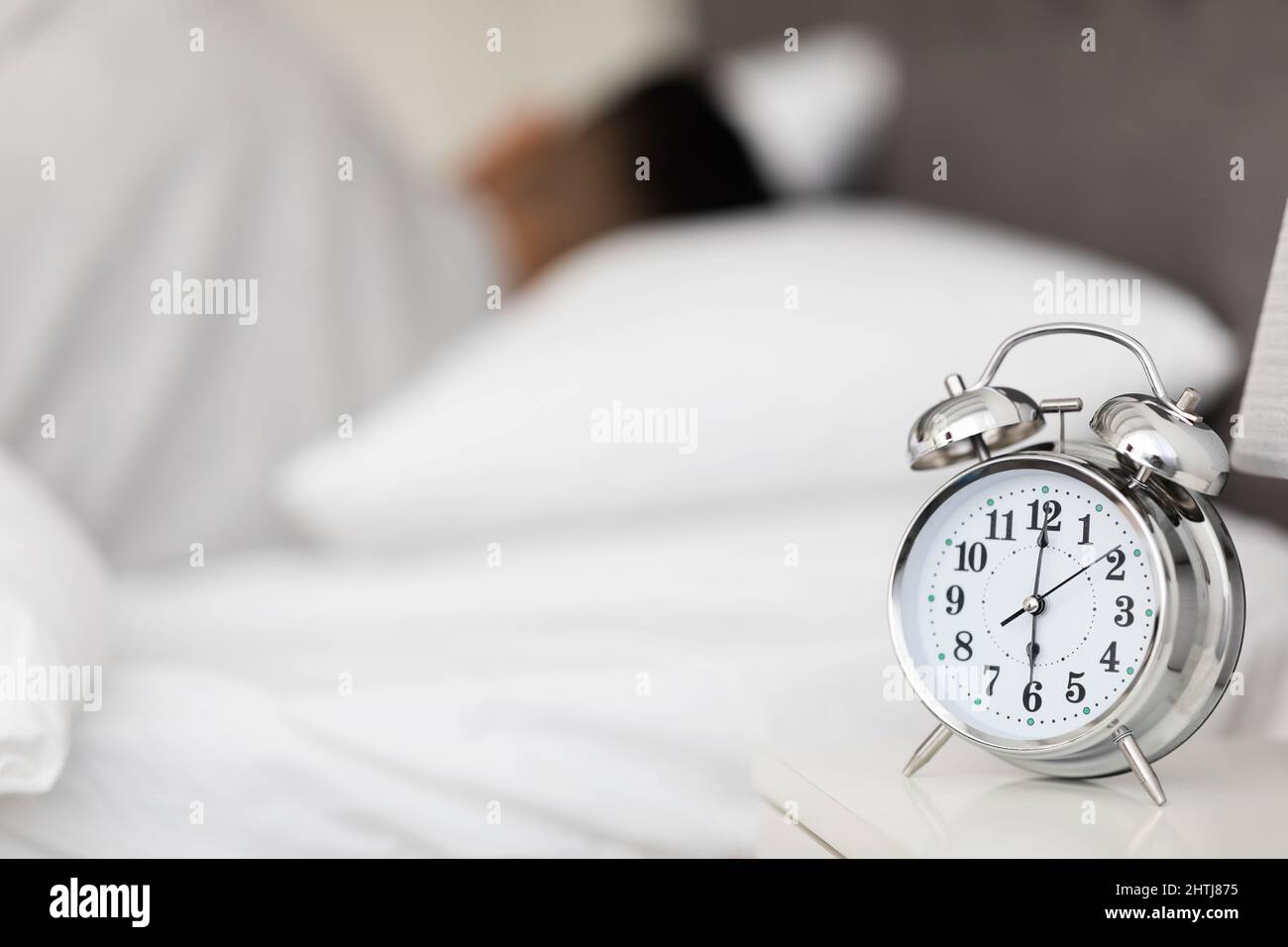 Wake Up Time. Vintage Alarm Clock Standing On Bedside Table In Bedroom Stock Photo