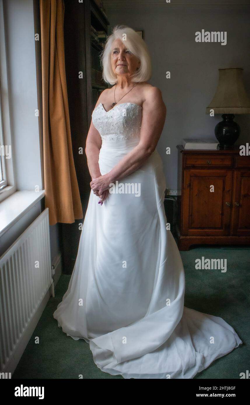 Online Dating Fraud.' Hazel Wilkins with documents and wedding dress Stock Photo