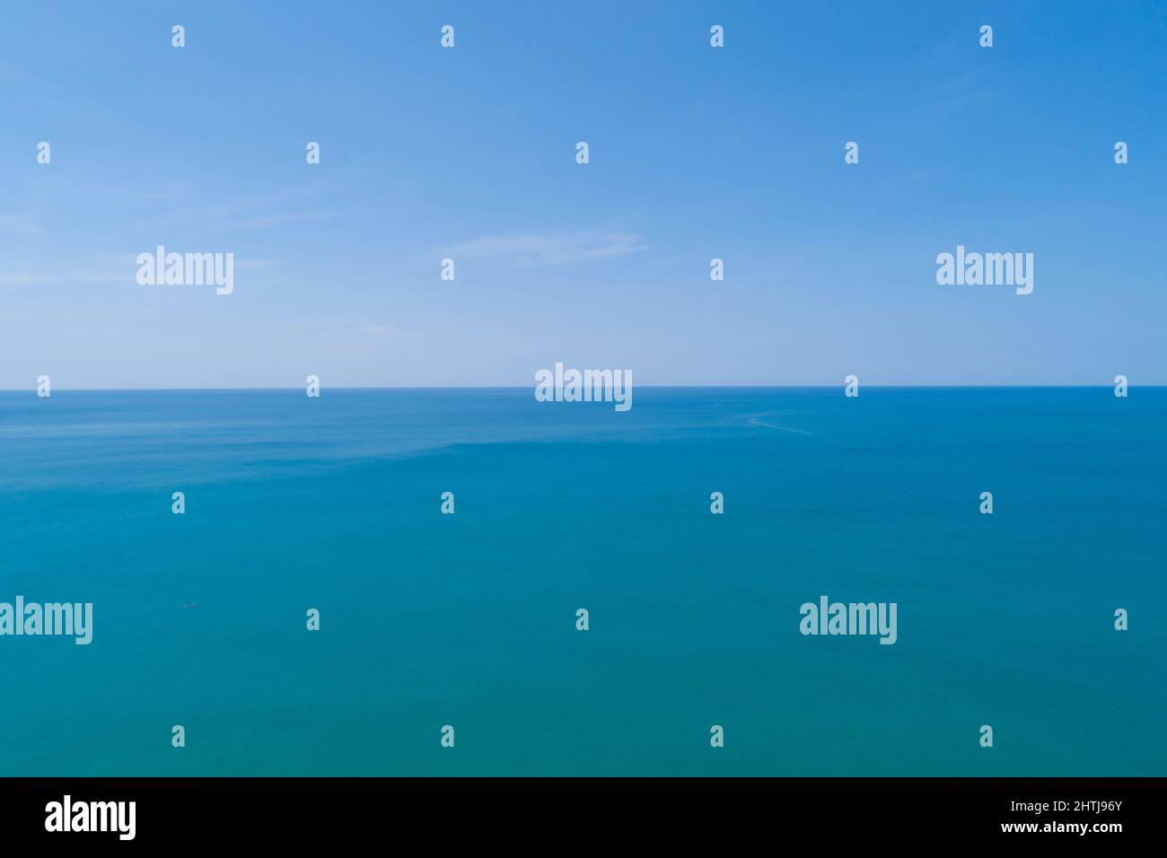 Aerial view of a blue sea surface water texture background and sun ...