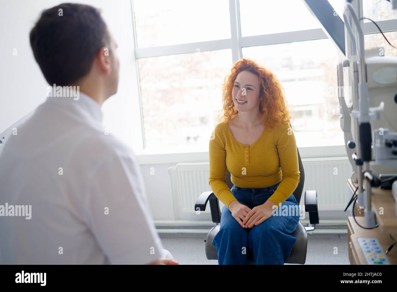 A patient and a doctor having a conversation in his clinic Stock Photo