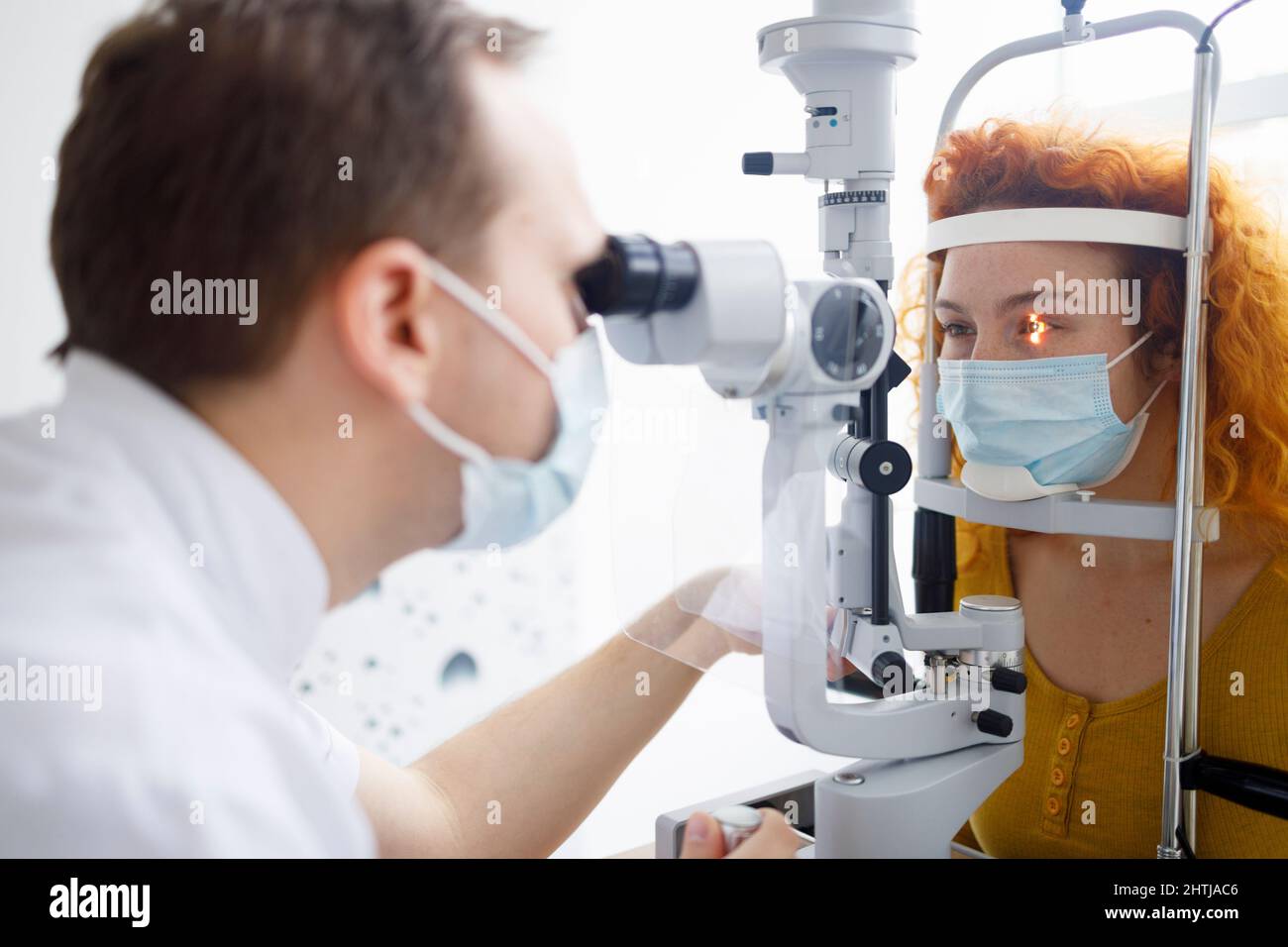 A female patient and her doctor during an eye examination in a professional eye clinic Stock Photo