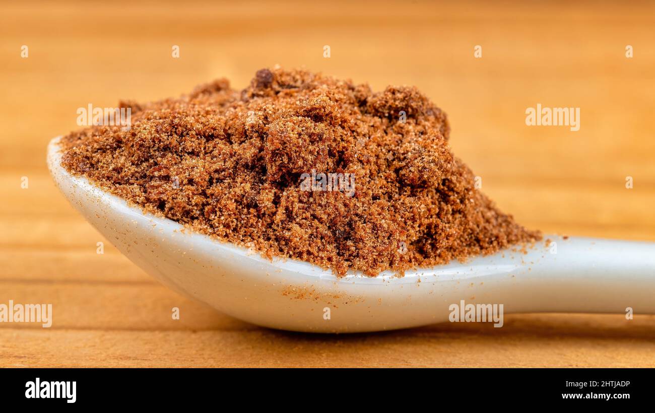 Ground food ingredients in a white spoon, macro Stock Photo