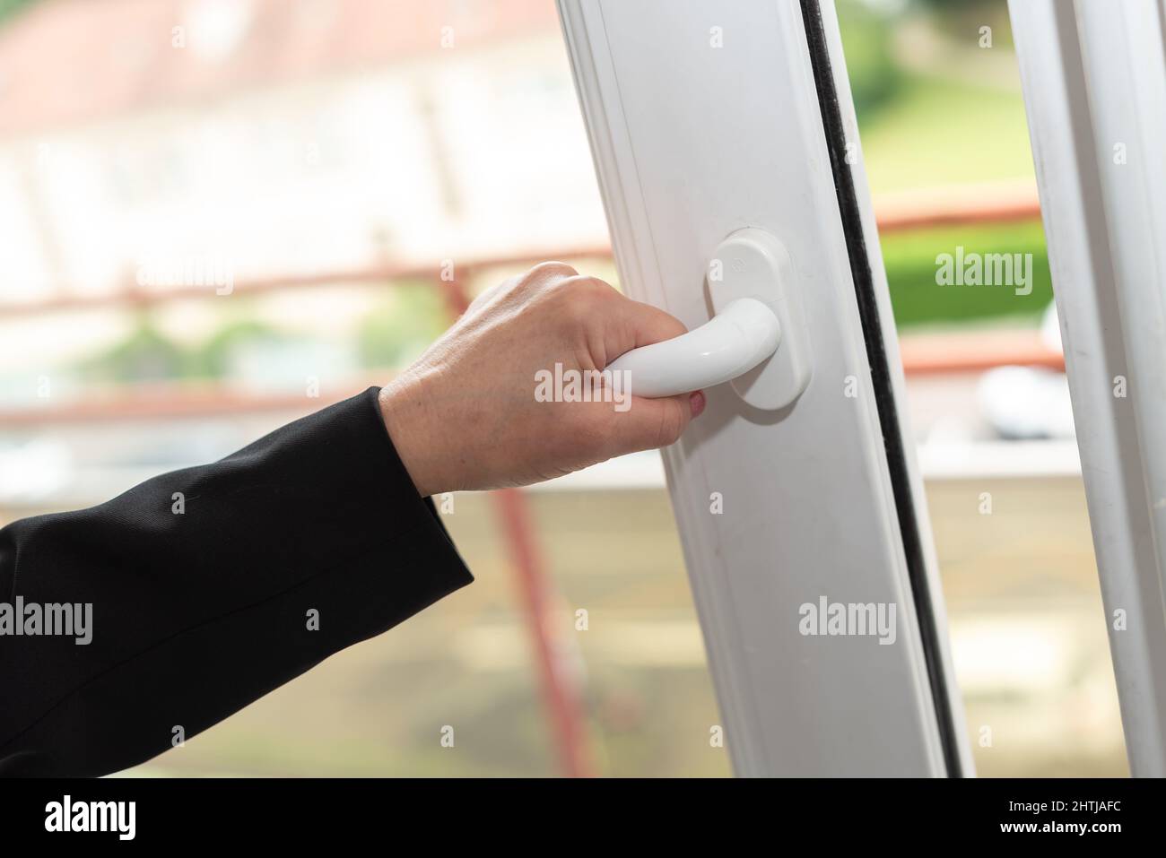 Female hand opening a window Stock Photo - Alamy
