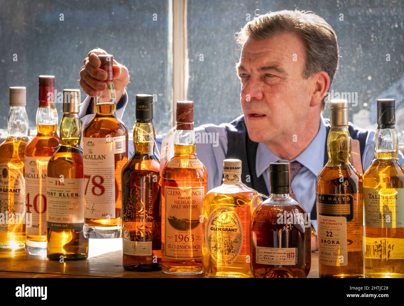 Bonhams' Head of Whisky Martin Green inspects a bottle of one of the oldest  known Macallan Scotch Whiskys ever produced, The Macallan-78 year old,  which leads Bonhams Whisky sale in Edinburgh on