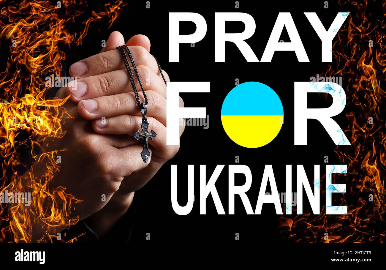 Pray for ukraine. hands pray on ukraine flag Stock Photo Alamy