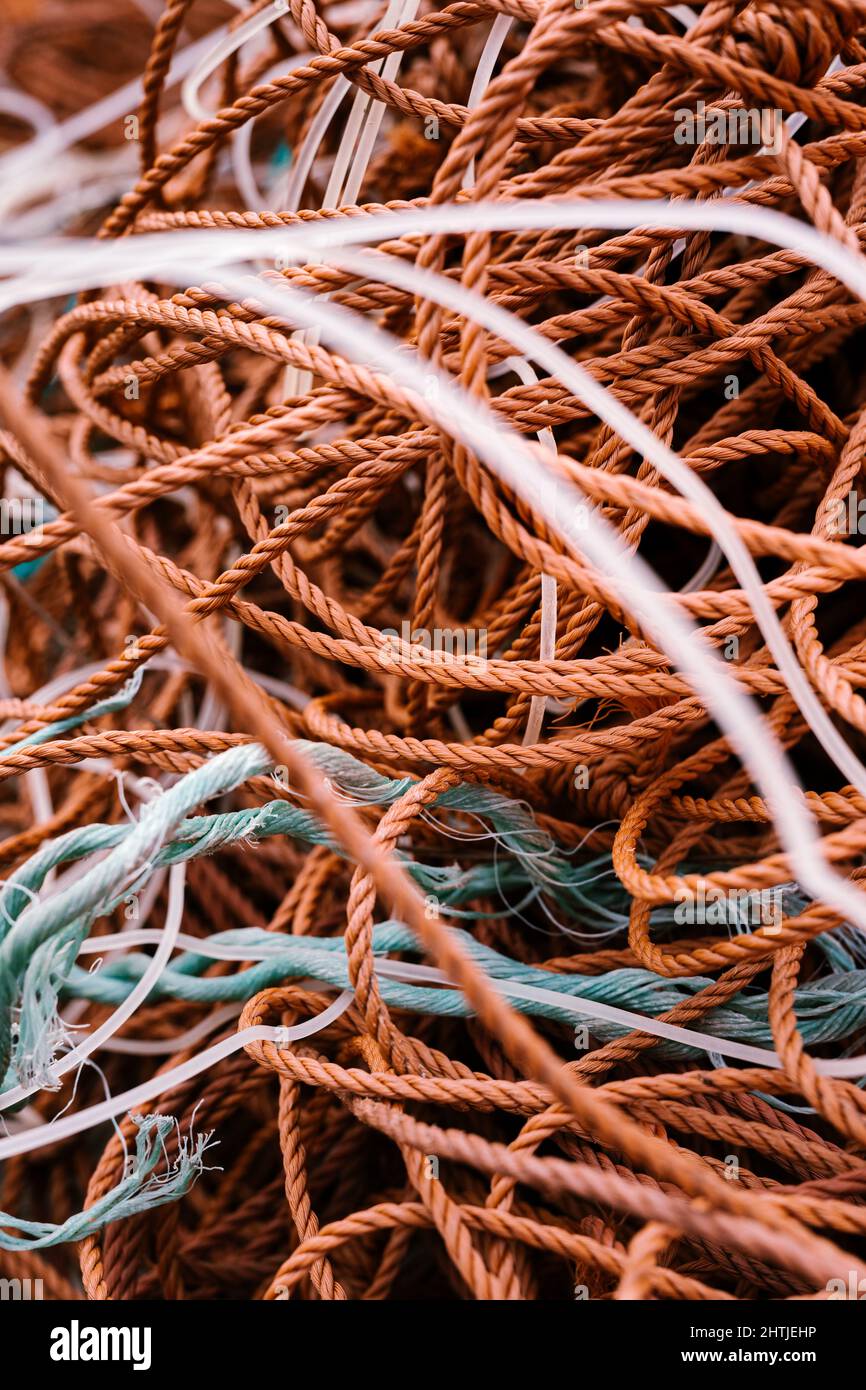 High angle of bunch of entangled fishing nets launched from boat in rippled river Stock Photo