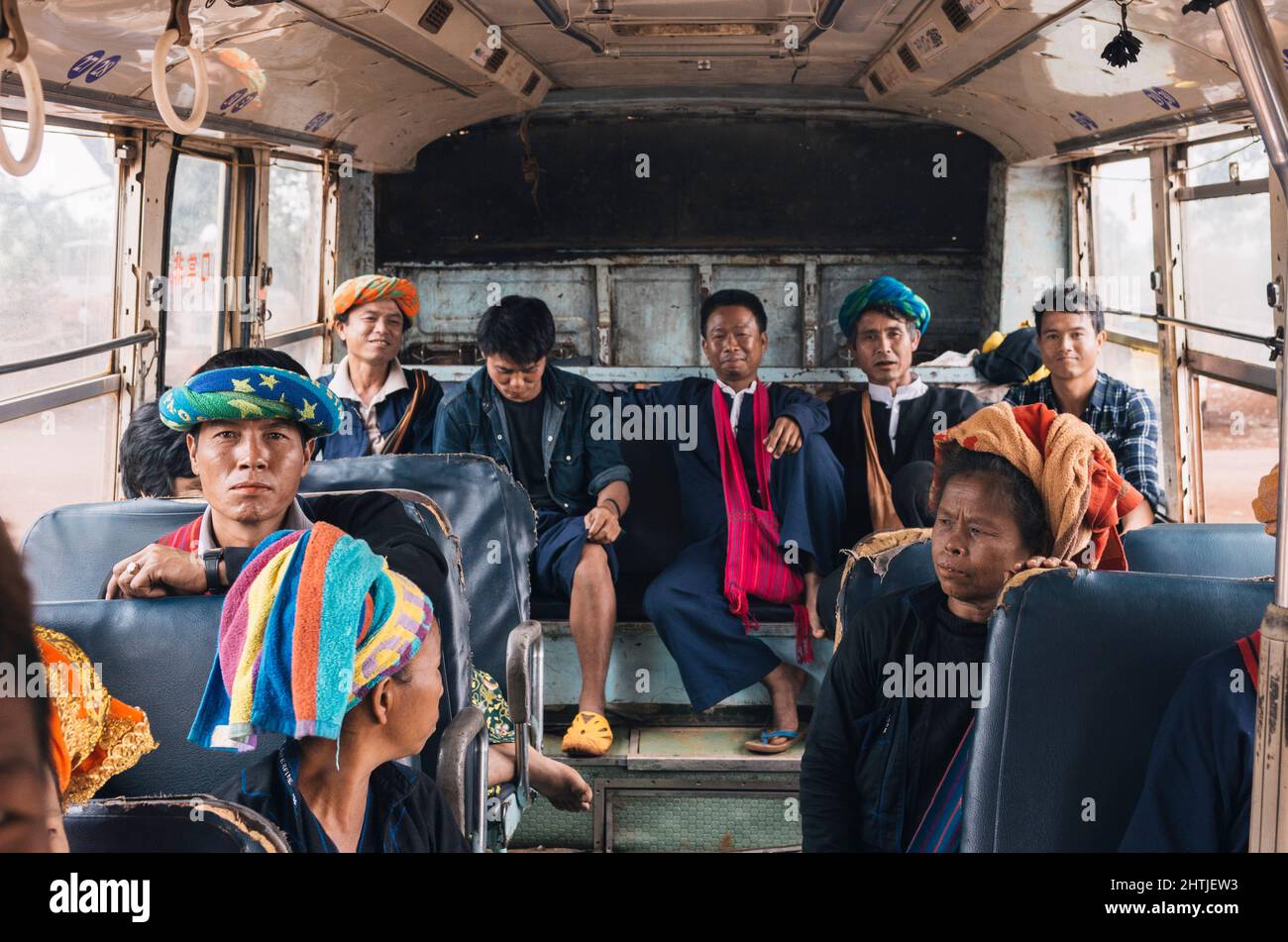 Kakku, Myanmar - 04.16.2017: Asian men from Karen ethnic minority with traditional towel turban in bus Stock Photo