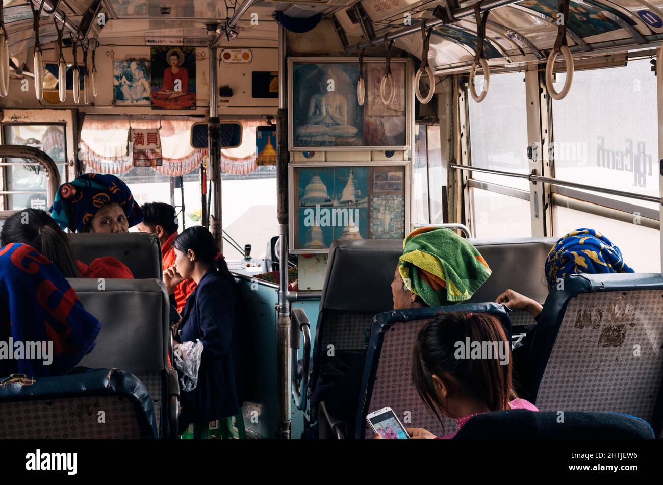 Kakku, Myanmar - 04.16.2017: Ethnic passengers with traditional towel turban in bus Stock Photo