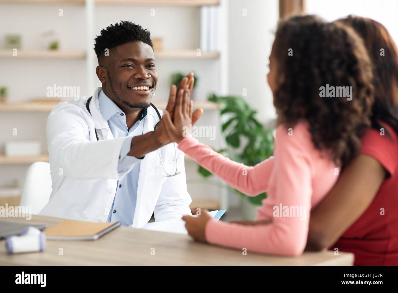 Black mother and daughter at appointment with doctor Stock Photo - Alamy