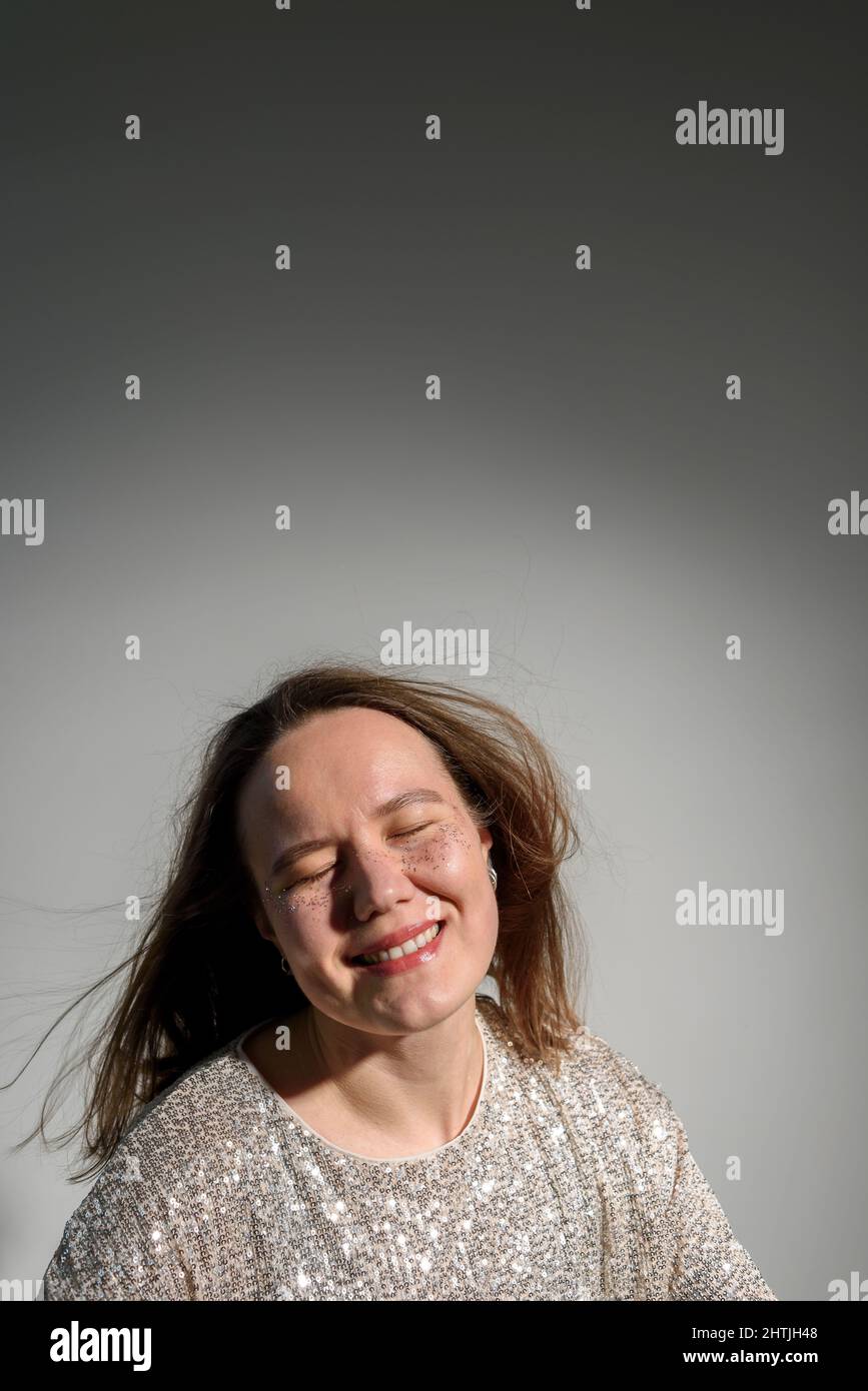 Happy smiling woman with sparkles on her face as freckles Stock Photo