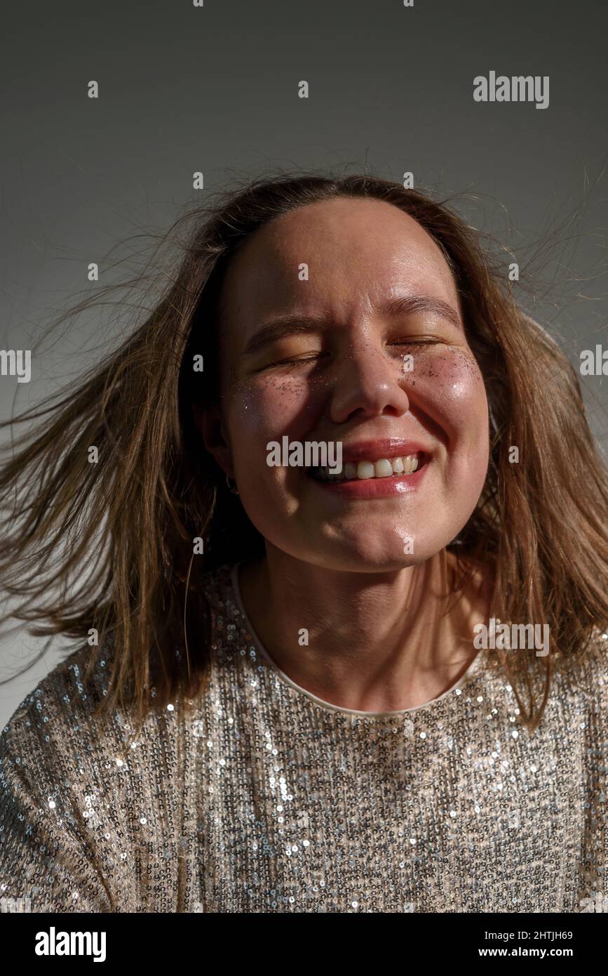 Happy smiling woman with sparkles on her face as freckles Stock Photo