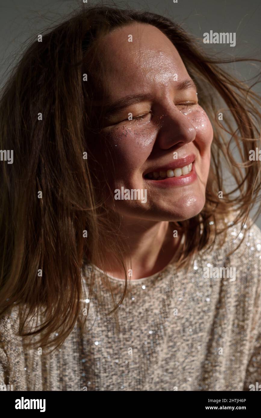 Happy smiling woman with sparkles on her face as freckles Stock Photo
