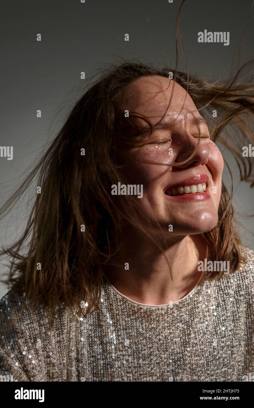 Happy smiling woman with sparkles on her face as freckles Stock Photo