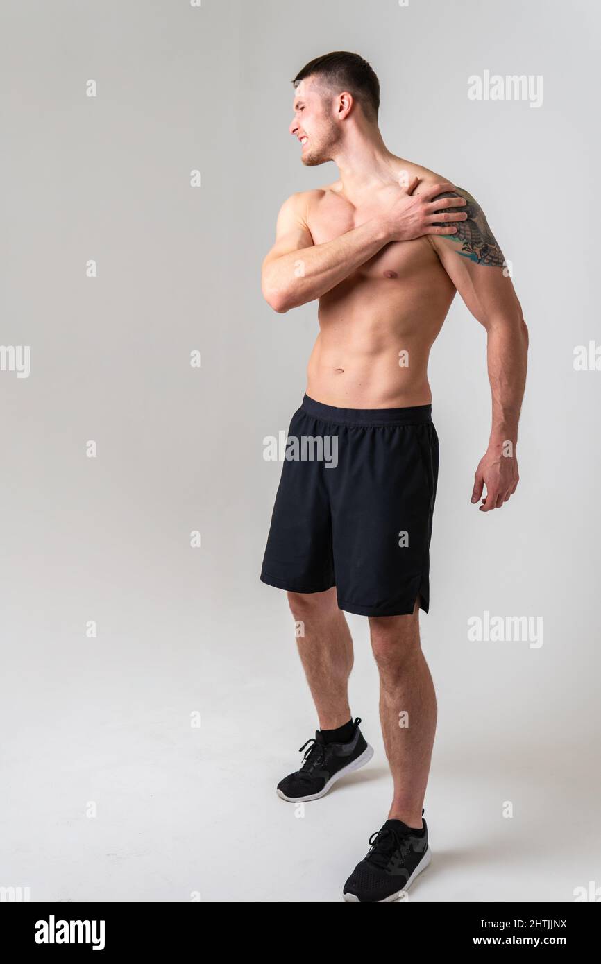 A sore shoulder joint muscle in a white man on a white background hurt ...