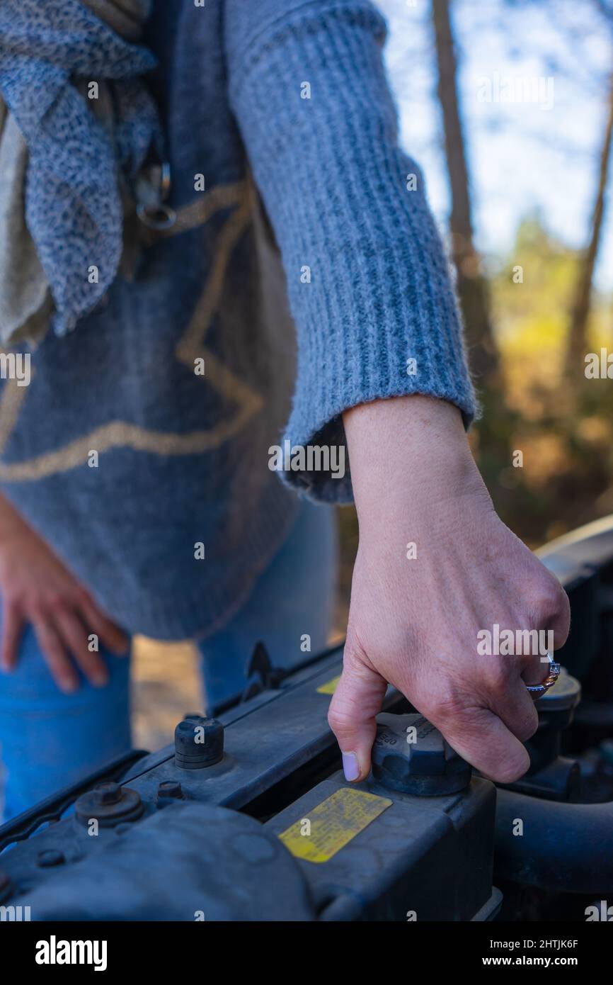 close-up of the hand adult woman repairing car engine Stock Photo